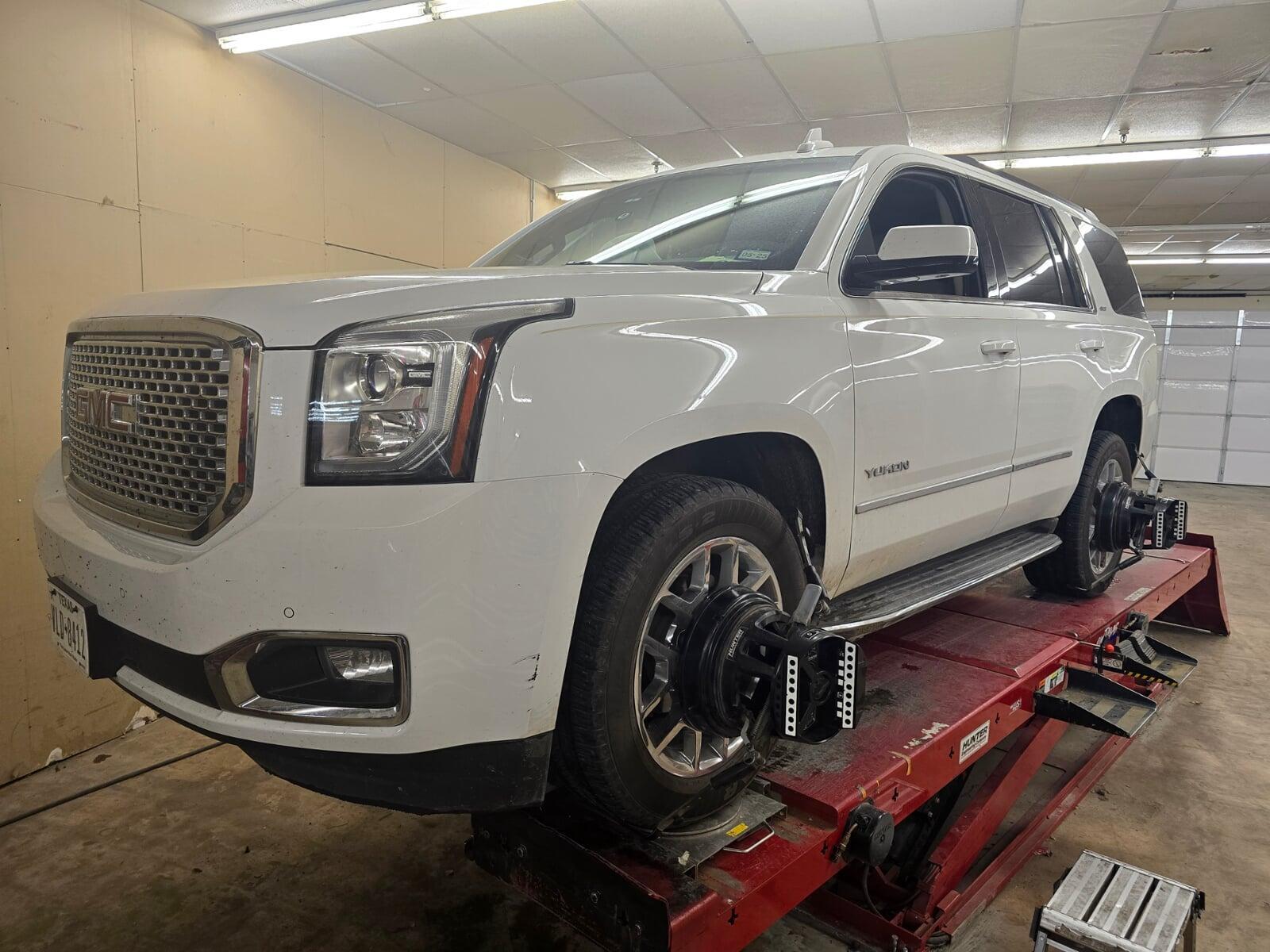 GMC Denali on an alignment rack with alignment in progress