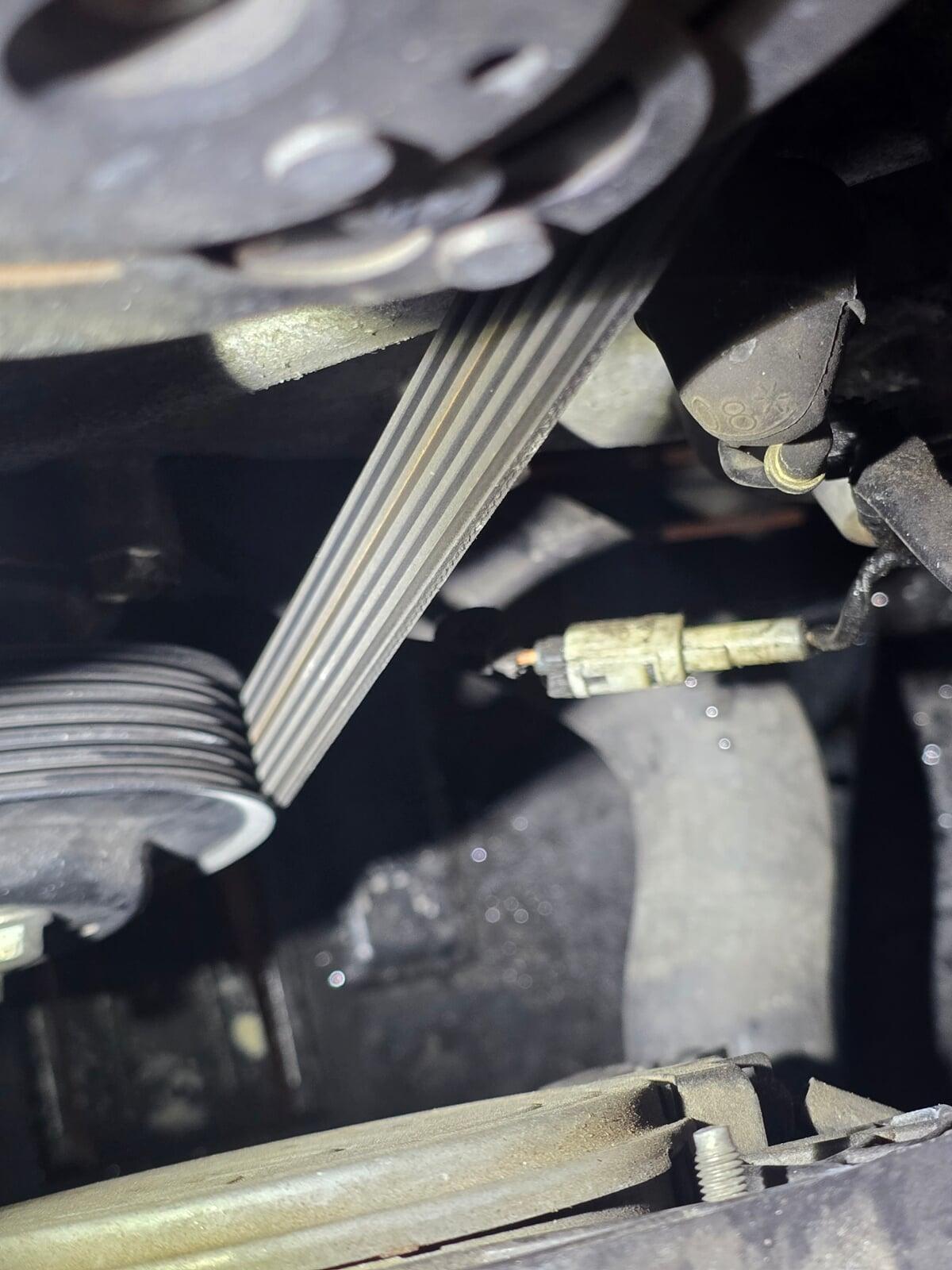 Image of a/c compressor and belt inspection.