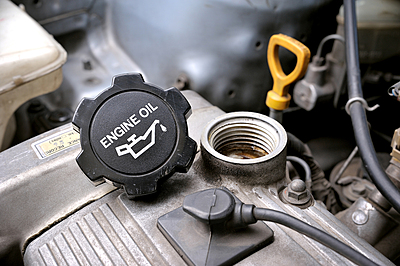 image showing oil fill cap is off when adding oil